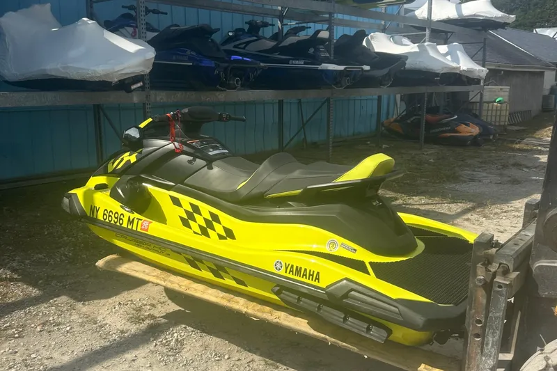 Slide: The Image of 2023 Yamaha WaveRunner VX Cruiser HO in vibrant yellow, parked outdoors. - 9