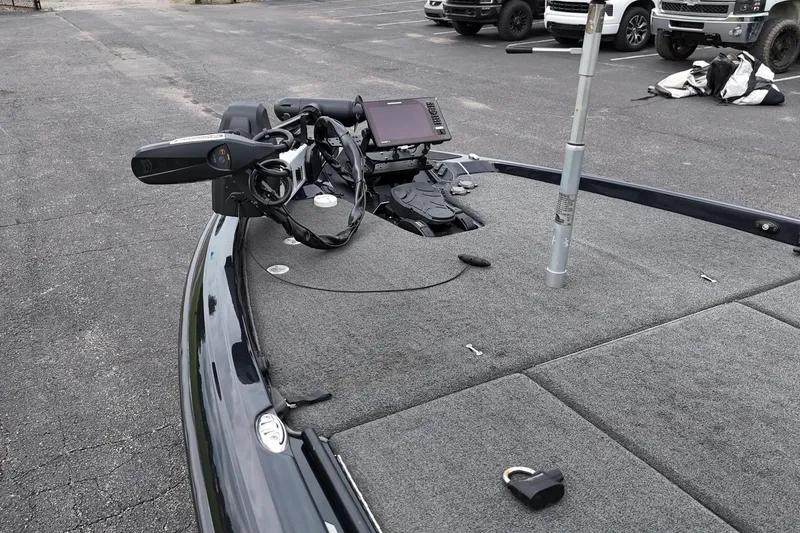 Slide: The Image of 2021 Skeeter FXR21 Apex boat with advanced navigation equipment in a parking lot. - 12