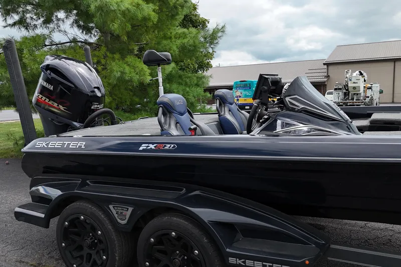 Slide: The Image of 2021 Skeeter FXR21 Apex boat with Yamaha engine, parked outdoors. - 17