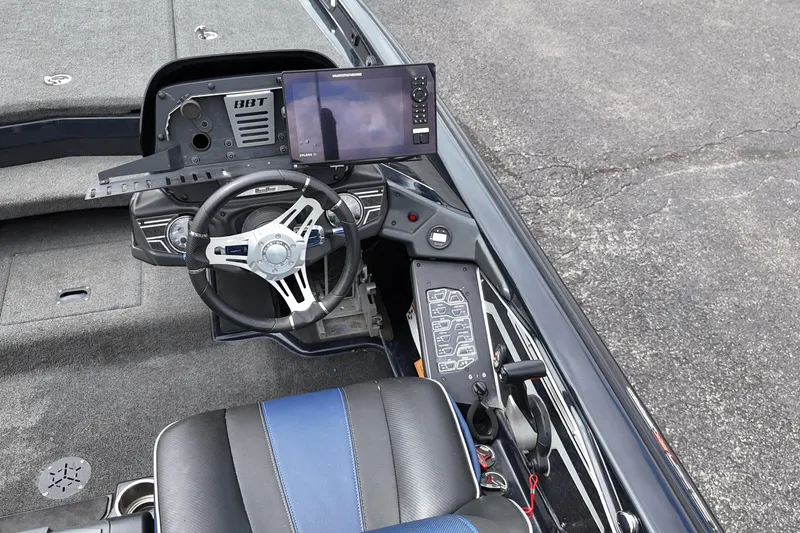 Slide: The Image of 2021 Skeeter FXR21 Apex boat cockpit with steering wheel and navigation display. - 20