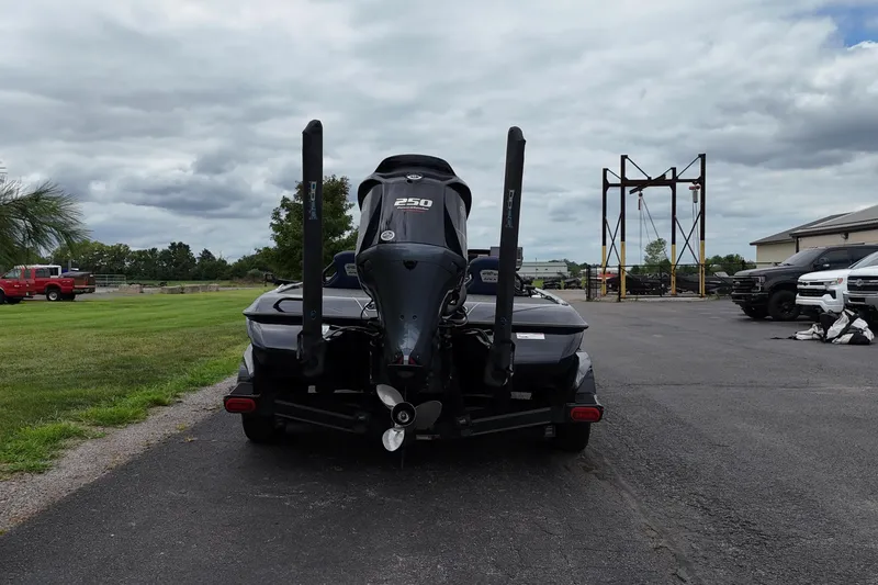 Slide: The Image of 2021 Skeeter FXR21 Apex boat with powerful outboard motor, parked on a paved area. - 3