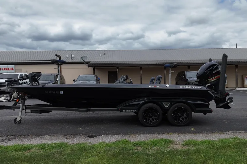 Slide: The Image of 2021 Skeeter FXR21 Apex bass boat on trailer, parked outdoors. - 4