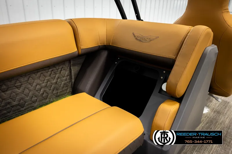 Slide: The Image of 2026 Bennington MFBSE boat interior with tan leather seating and storage compartment. - 26