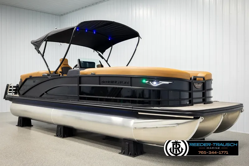 Slide: The Image of 2026 Bennington MFBSE pontoon boat with canopy, displayed indoors at Reeder-Trausch Marine. - 3