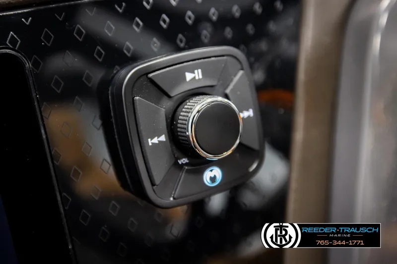 Slide: The Image of Close-up of 2026 Bennington MFBSE audio control panel with volume knob. - 31