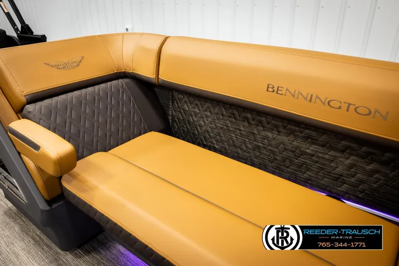 Slide: The Image of Luxurious 2026 Bennington MFBSE boat seating with tan and dark upholstery, featuring Reeder-Trausch Marine logo. - 39