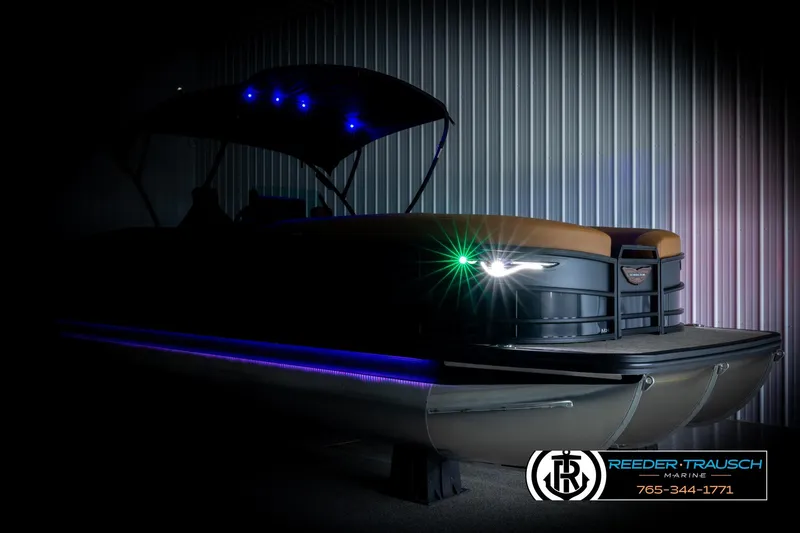 Slide: The Image of 2026 Bennington MFBSE pontoon boat with illuminated LED lights in a dimly lit setting. - 4