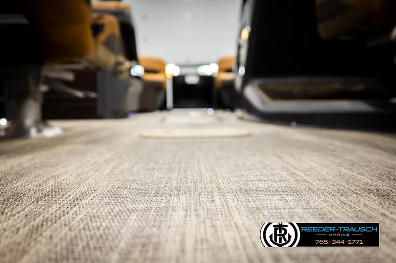 Slide: The Image of Interior view of 2026 Bennington MFBSE boat with carpet flooring, Reeder-Trausch Marine logo. - 45