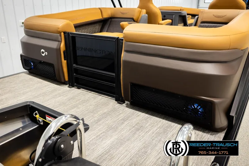 Slide: The Image of 2026 Bennington MFBSE boat interior with tan seating and Reeder-Trausch Marine branding. - 46