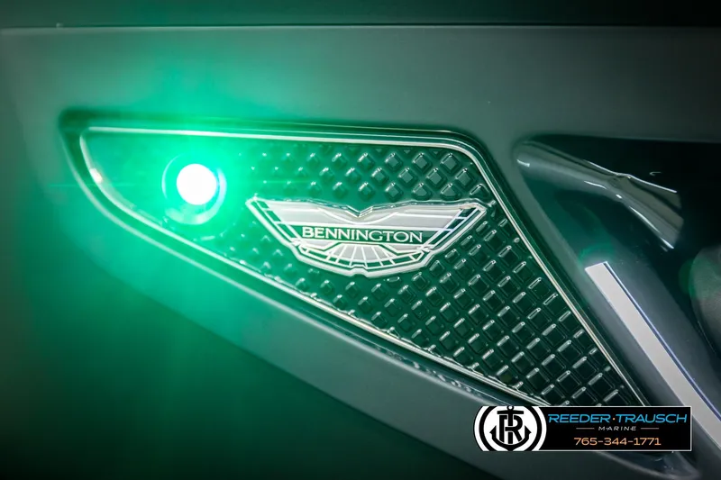 Slide: The Image of 2026 Bennington MFBSE illuminated logo with green light, Reeder-Trausch Marine branding. - 49
