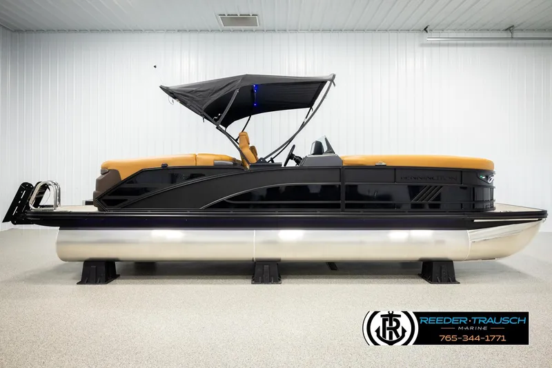Slide: The Image of 2026 Bennington MFBSE pontoon boat with canopy in showroom, side view. - 5
