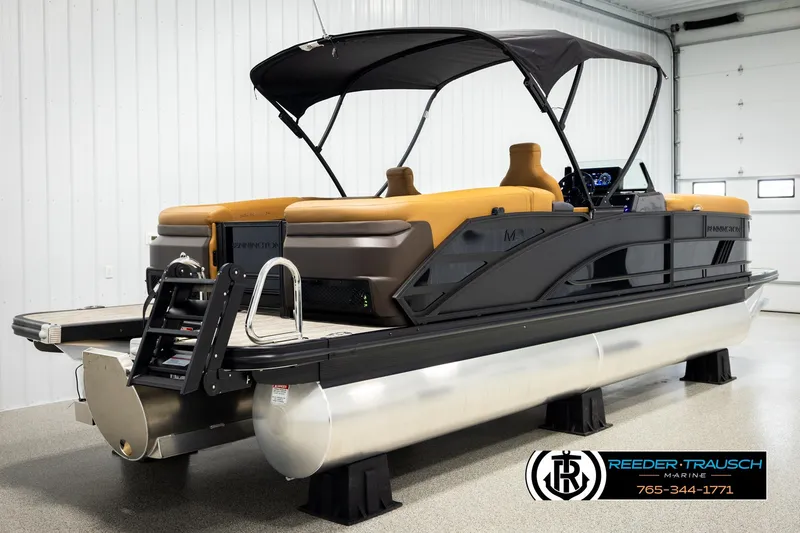 Slide: The Image of 2026 Bennington MFBSE pontoon boat with canopy in showroom, featuring sleek design and modern amenities. - 6