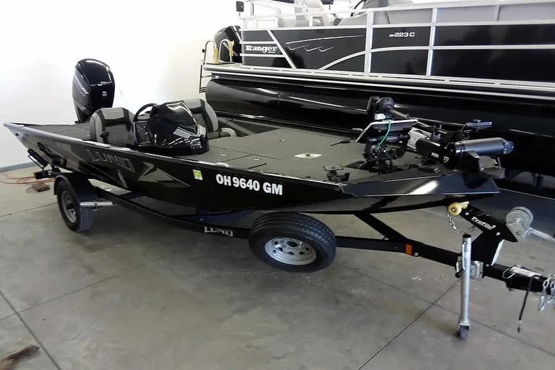 The Image of 2024 Lund 1775 Renegade fishing boat on trailer in showroom. - 0