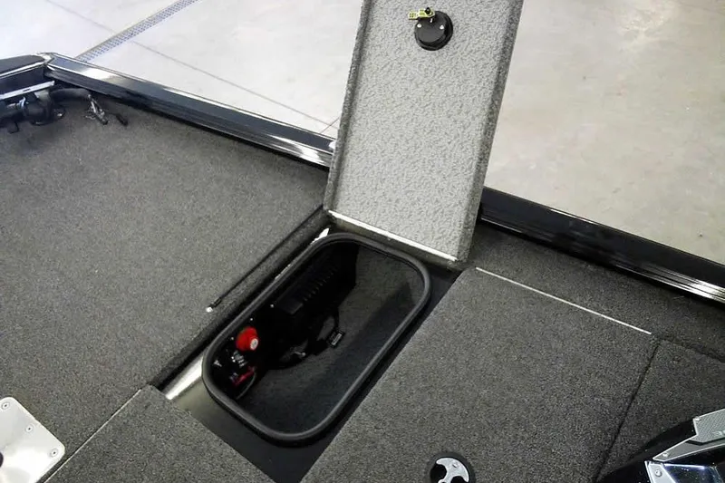 Slide: The Image of 2024 Lund 1775 Renegade boat storage compartment with open hatch, showcasing interior details. - 16