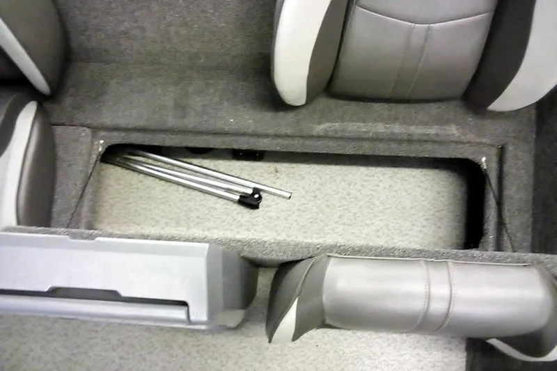 Slide: The Image of 2024 Lund 1775 Renegade boat interior storage compartment with folded metal poles. - 22