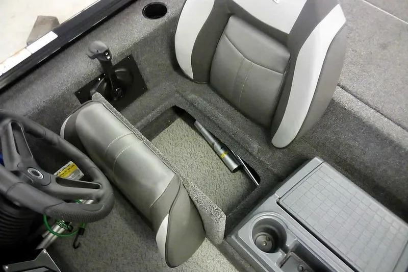 Slide: The Image of 2024 Lund 1775 Renegade boat interior with steering wheel, seat, and storage compartment. - 23