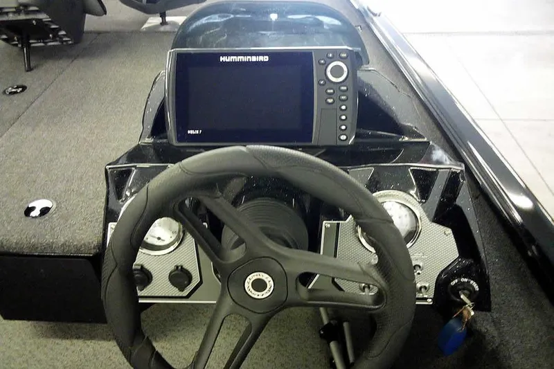 Slide: The Image of 2024 Lund 1775 Renegade boat dashboard with steering wheel and Humminbird fish finder. - 26