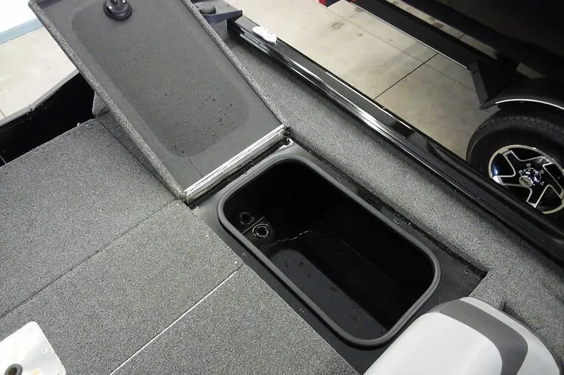 Slide: The Image of 2024 Lund 1775 Renegade boat storage compartment with open lid, showcasing interior space. - 28