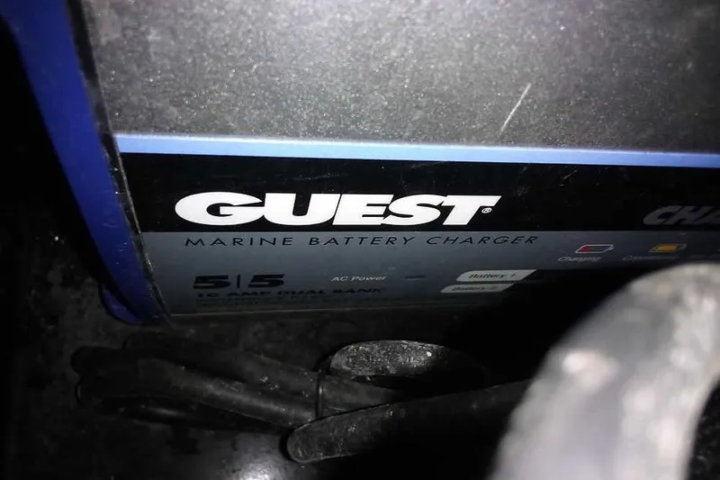 Slide: The Image of Marine battery charger labeled "Guest" in a 2024 Lund 1775 Renegade boat. - 31