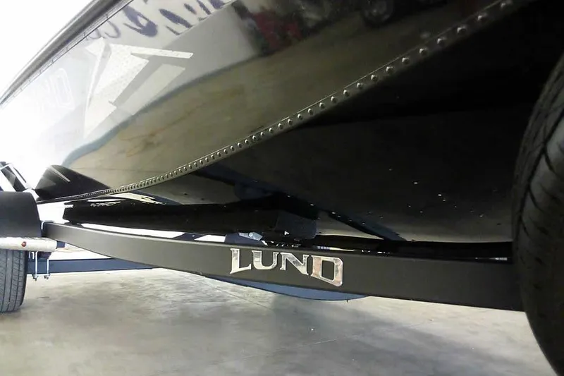 Slide: The Image of 2024 Lund 1775 Renegade boat on trailer, showcasing sleek black hull design. - 5