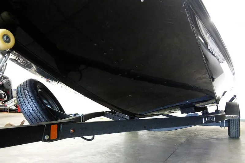 Slide: The Image of 2024 Lund 1775 Renegade boat on trailer, viewed from below in a garage. - 6