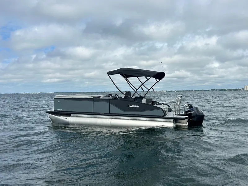 Slide: The Image of 2026 Harris Sunliner 230 pontoon boat on the water. - 1
