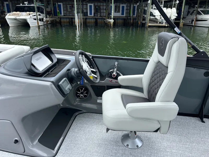 Slide: The Image of Interior of 2026 Harris Sunliner 230 boat with luxurious captain's chair. - 14