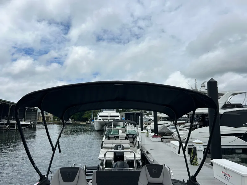 Slide: The Image of Harris Sunliner 230 boat docked at marina, 2026 model. - 22