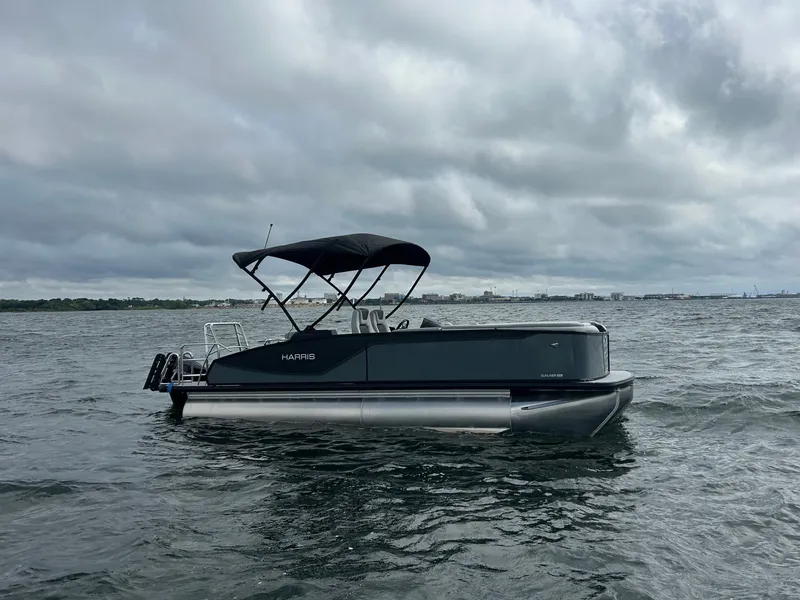 Slide: The Image of Harris Sunliner 230 pontoon boat 2026 on choppy waters. - 5
