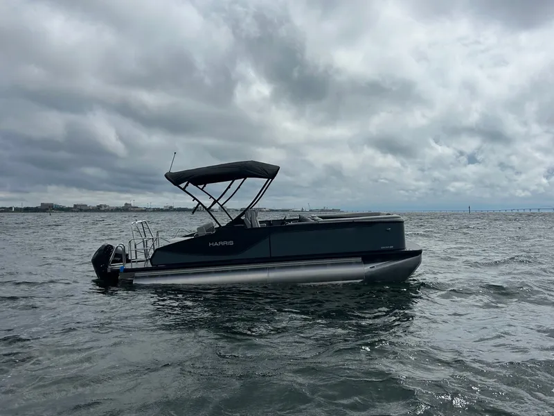 Slide: The Image of Harris Sunliner 230 pontoon boat 2026 on choppy waters. - 6