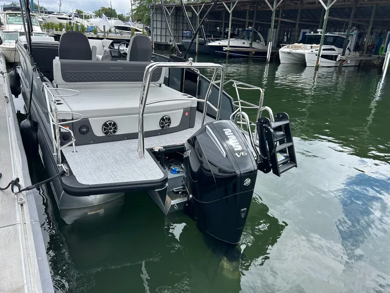 Slide: The Image of 2026 Harris Sunliner 230 with Mercury V6 engine at dock. - 7