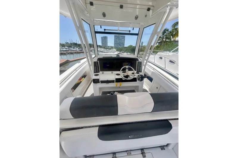 Slide: The Image of 2021 Robalo R302 Center Console boat interior with steering wheel and dashboard view. - 12