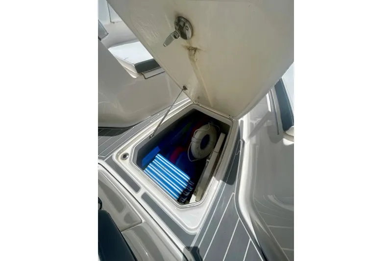 Slide: The Image of Open storage compartment on 2021 Robalo R302 Center Console boat. - 4