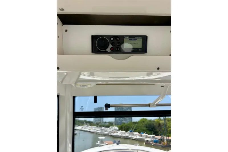 Slide: The Image of 2021 Robalo R302 Center Console boat with Fusion stereo system, marina view. - 6