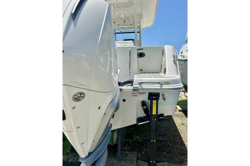 Slide: The Image of 2021 Robalo R302 Center Console boat with powerful outboard engine, docked under clear blue sky. - 9