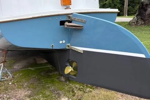 Slide: The Image of 1981 Mark O Atlantic City 24 boat stern with visible propeller and rudder on grass. - 3