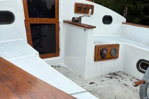 Slide: The Image of 1981 Mark O Atlantic City 24 sailboat cockpit with wooden accents and control panel. - 4