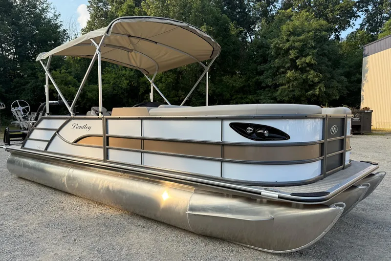 The Image of 2026 Bentley Pontoons Legacy 243 Swingback EXT, elegant design, parked outdoors with canopy. - 1