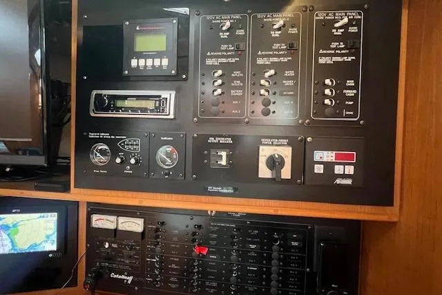 Slide: The Image of Control panel of a 2003 Catalina 470 Sloop with Wing Keel, featuring navigation and electrical systems. - 10