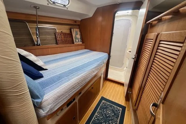 Slide: The Image of Cozy cabin interior of 2003 Catalina 470 Sloop with Wing Keel, featuring bed and wooden decor. - 12