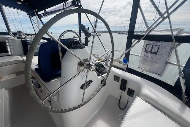 Slide: The Image of 2003 Catalina 470 Sloop cockpit with steering wheel and navigation equipment. - 18
