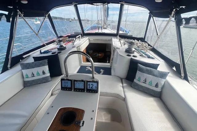 Slide: The Image of 2003 Catalina 470 Sloop with Wing Keel, featuring a spacious cockpit and nautical-themed cushions. - 20