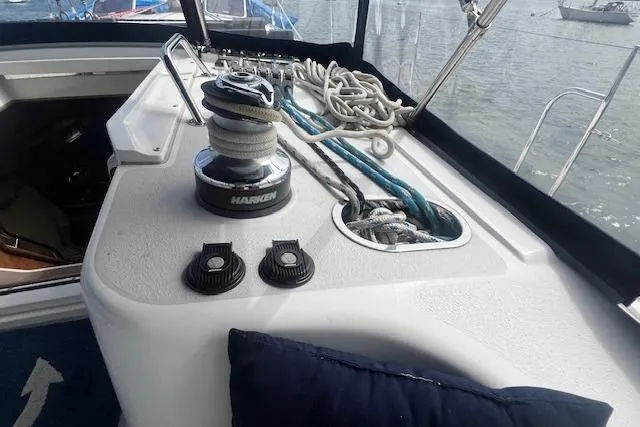 Slide: The Image of 2003 Catalina 470 Sloop cockpit with winch, ropes, and nautical equipment. - 21