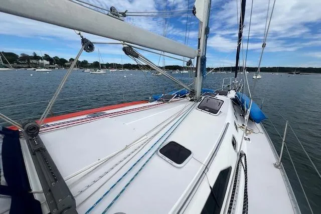 Slide: The Image of 2003 Catalina 470 Sloop with Wing Keel sailing on a calm lake under blue skies. - 23