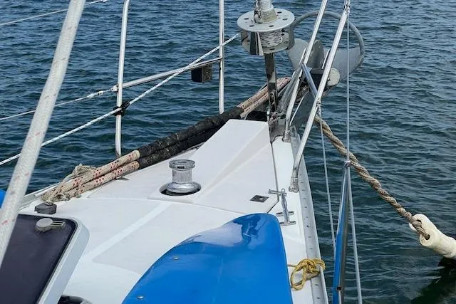 Slide: The Image of 2003 Catalina 470 Sloop with wing keel, deck view, sailing on calm waters. - 25