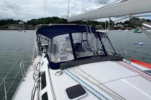 Slide: The Image of 2003 Catalina 470 Sloop with wing keel, docked in a serene harbor setting. - 26