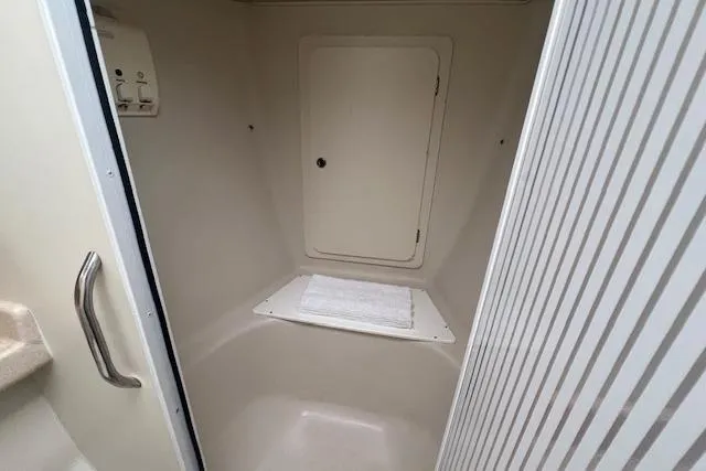 Slide: The Image of Interior of 2003 Catalina 470 Sloop sailboat, featuring a compact shower area. - 28