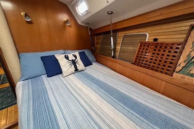 Slide: The Image of Cozy cabin interior of 2003 Catalina 470 Sloop with striped bedding and nautical decor. - 30