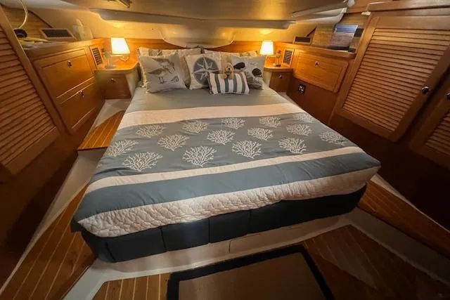 Slide: The Image of Cozy cabin interior of 2003 Catalina 470 Sloop with wing keel, featuring a comfortable bed. - 31