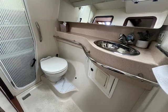 Slide: The Image of Bathroom interior of 2003 Catalina 470 Sloop, featuring toilet, sink, and shower area. - 35